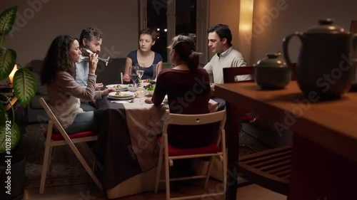 Group of young people dinning together. The camera moves. 4K, UHD