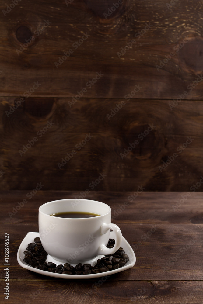 Cup of Coffee on a plate with coffee beans Cup of Coffee on a plate with coffee beans