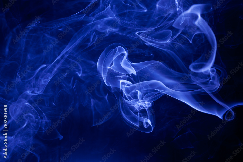 Fototapeta premium Blue smoke on a black background.