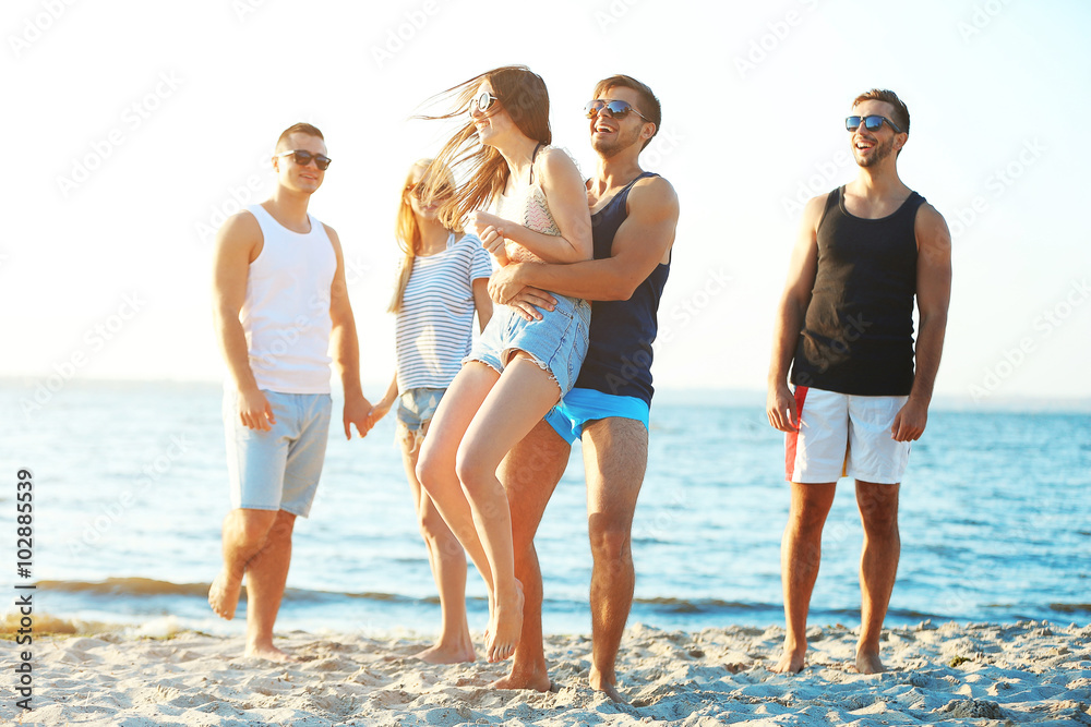 Happy friends having fun at the beach, outdoors Happy friends having fun at the beach, outdoors