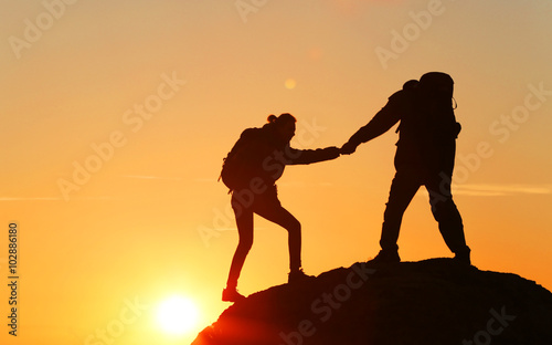 Man and woman climbing the mountain