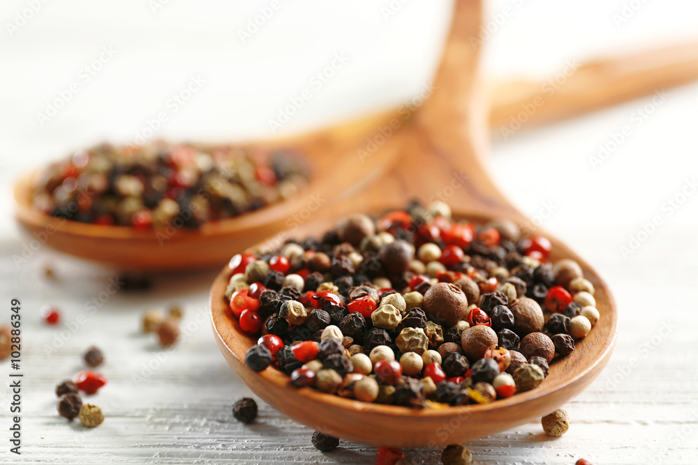 Two wooden spoons with pepper on the table, close-up Two wooden spoons with pepper on the table, close-up