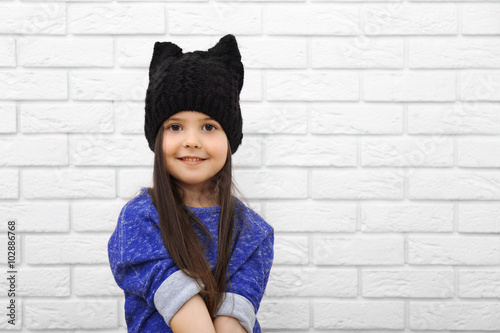 Little girl on a white bric...