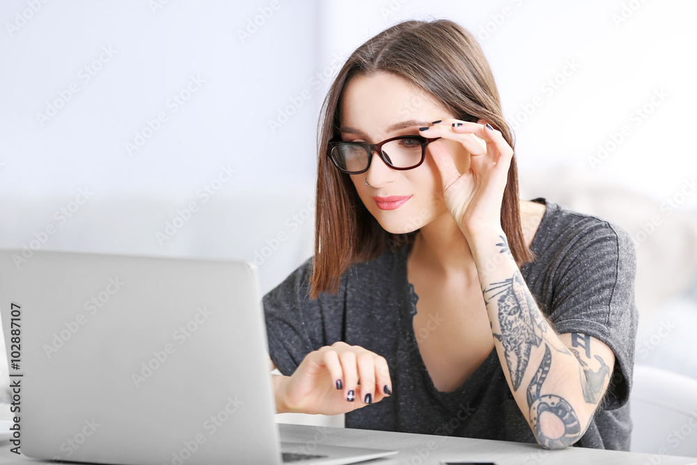 Woman sitting at the table and working with laptop Woman sitting at the table and working with laptop