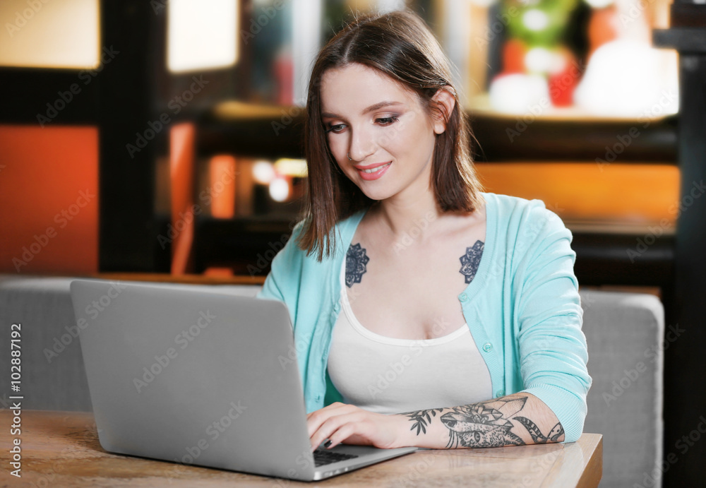 Young woman working with laptop in cafe Young woman working with laptop in cafe