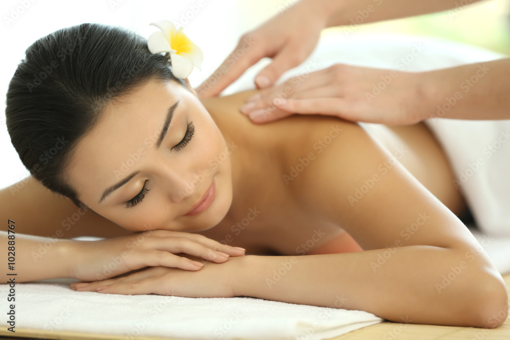 Masseur doing massage on woman back in the spa salon