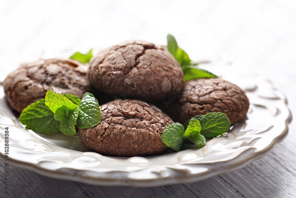 Chocolate chip cookie with mint in plate, closeup Chocolate chip cookie with mint in plate, closeup