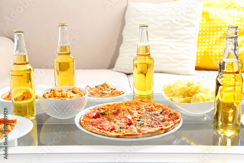 Table at home with pizza and drinks for friends