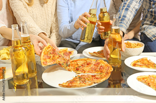 Friendly party with hot pizza and drinks  close up