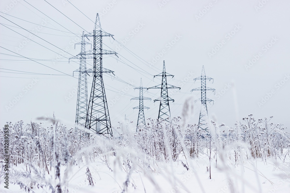 Electricity towers in winter. Blurred foreground Electricity towers in winter. Blurred foreground