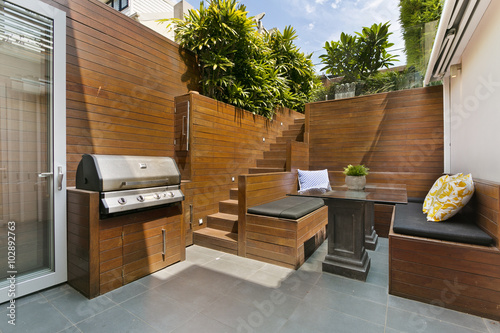 back yard with outdoor seating and barbecue with family. beautiful house