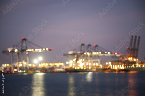 Blurred photo for Containers loading by crane in the sunset , Trade Port , Shipping