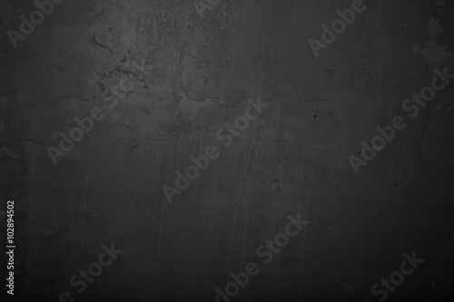 Highly detailed and empty black concrete wall. Dark background, horizontal
