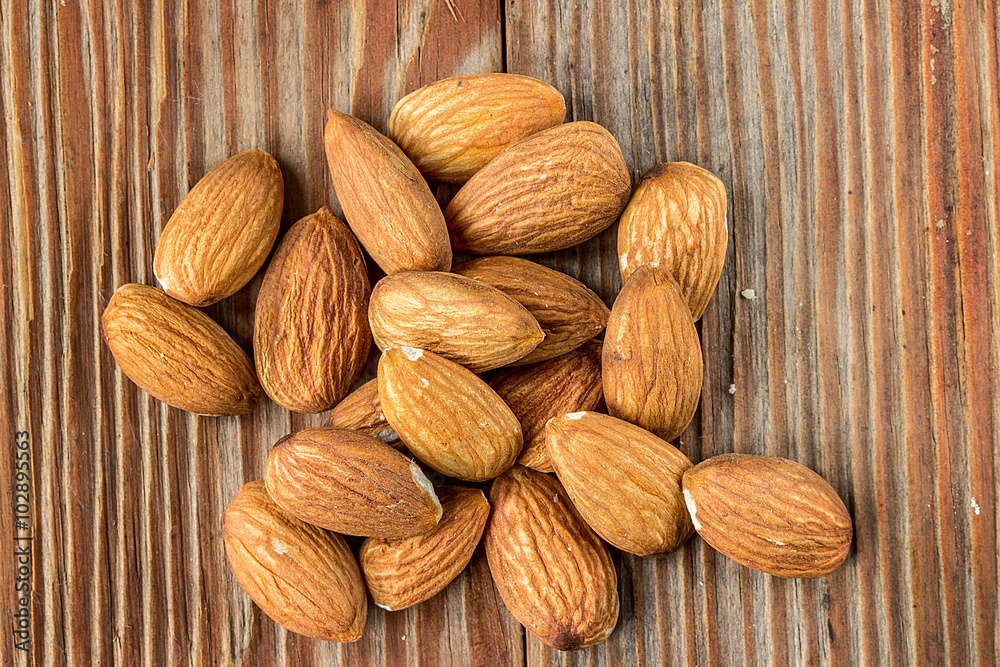 almonds on a wooden background almonds on a wooden background