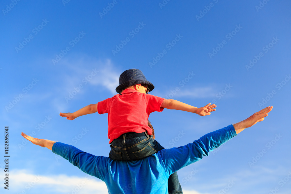 father and little son play on sky father and little son play on sky