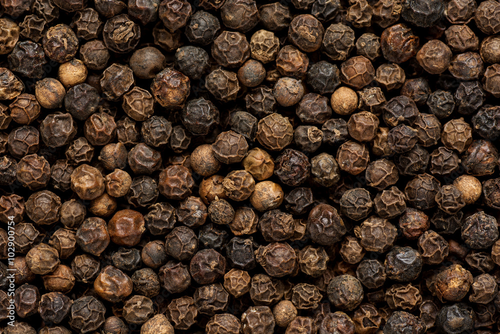 Black pepper grains as background close up Black pepper grains as background close up