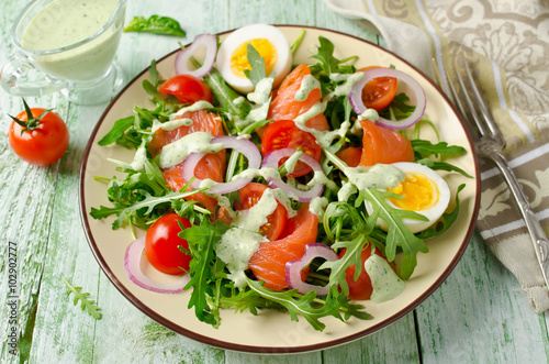 Smoked salmon salad with arugula, tomatoes, eggs and red onion
