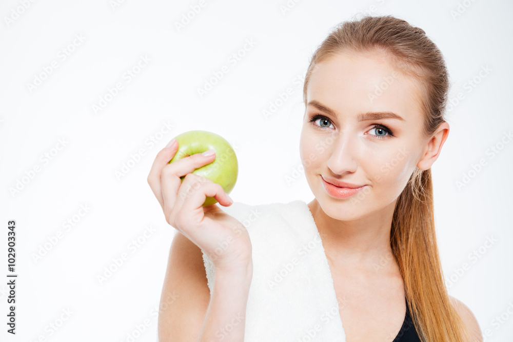 Beautiful young sportswoman holding apple Beautiful young sportswoman holding apple