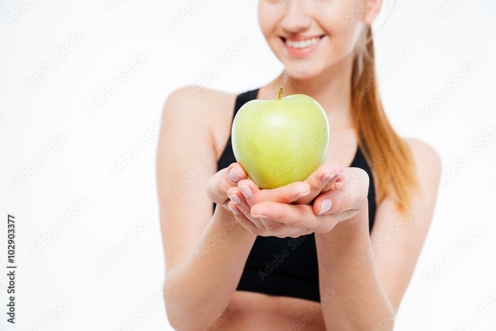 Fresh green apple holded by cheerful woman athlete Fresh green apple holded by cheerful woman athlete