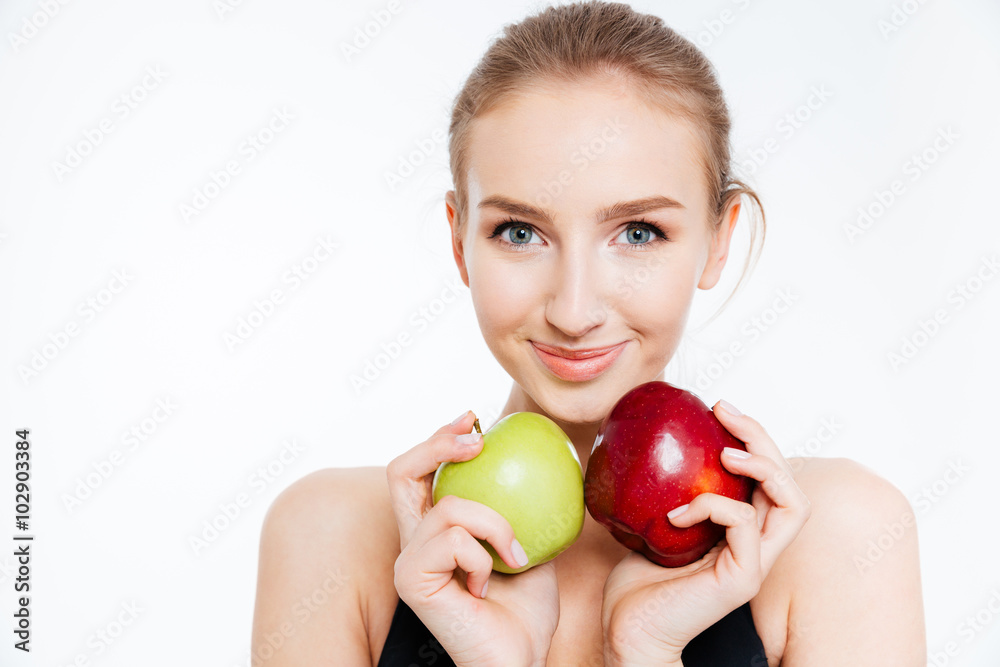 Closeup of smiling pretty sportswoman with green and red apples Closeup of smiling pretty sportswoman with green and red apples