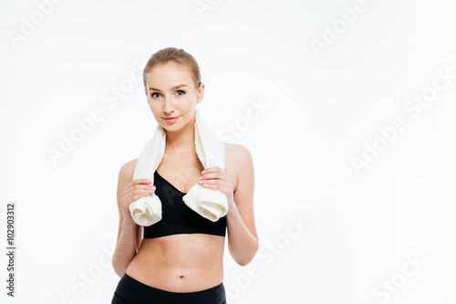Beautiful happy sportswoman standing with white towel on her neck