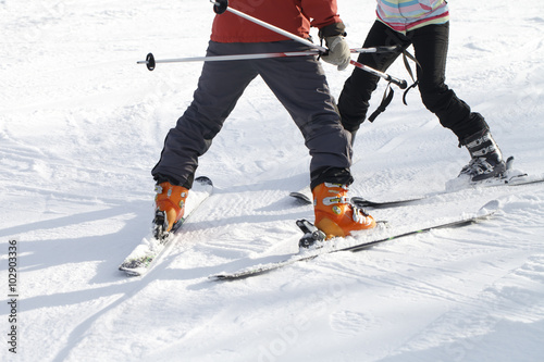 The instructor teaches skiing
