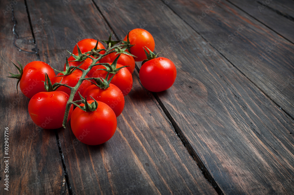 Fresh cherry tomatoes on wood background