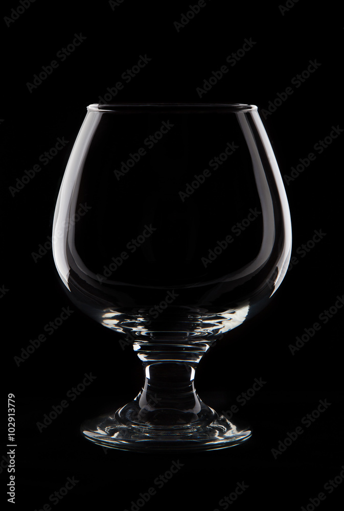 Empty cognaci glass on black background studio shot Empty cognaci glass on black background studio shot