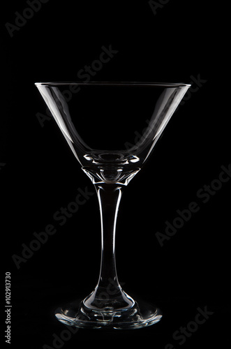 Empty  martini  glass on black background studio shot