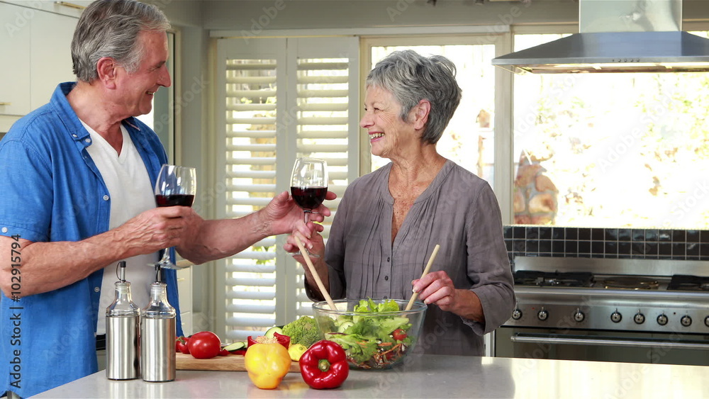 Happy senior couple making a salad Happy senior couple making a salad