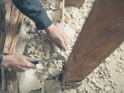 Person using hammer in rubble