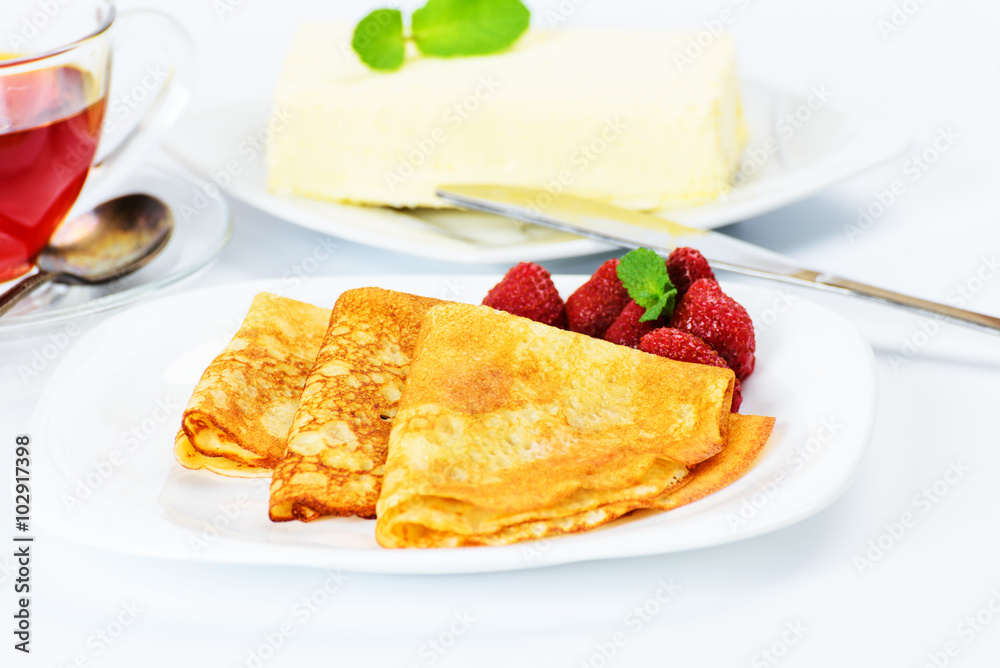 Russian pancakes with black tea and strawberries. Russian pancakes with black tea and strawberries.