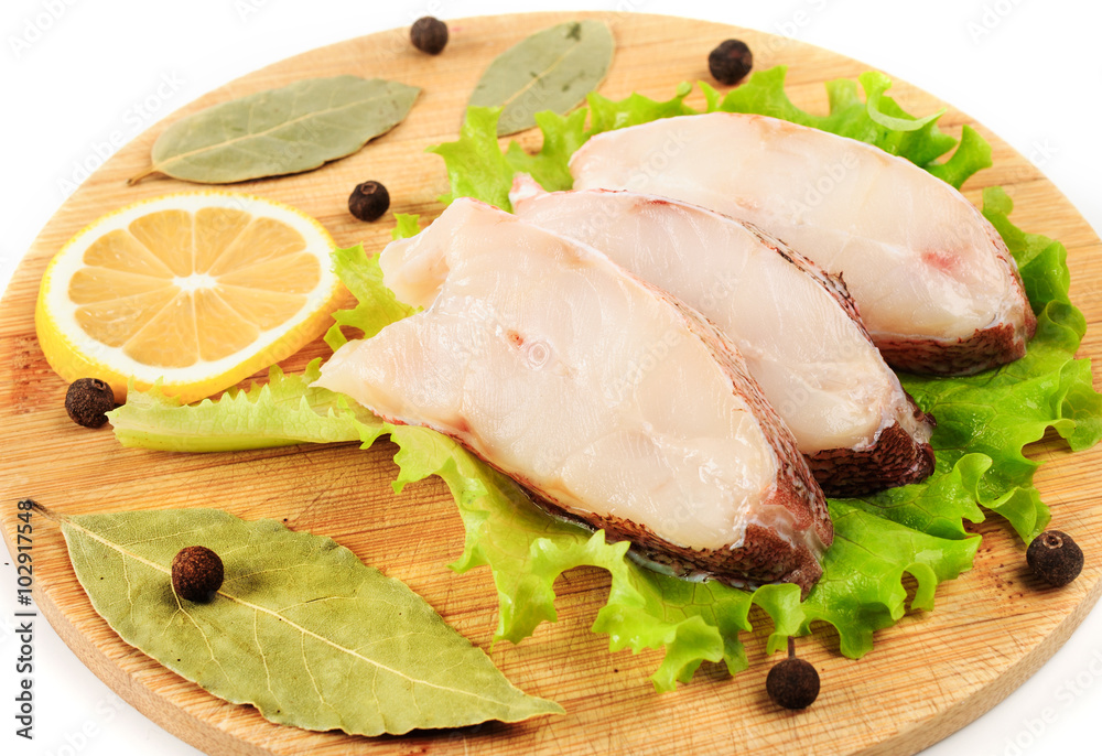 Pieces of sea bass on a cutting board. Pieces of sea bass on a cutting board.