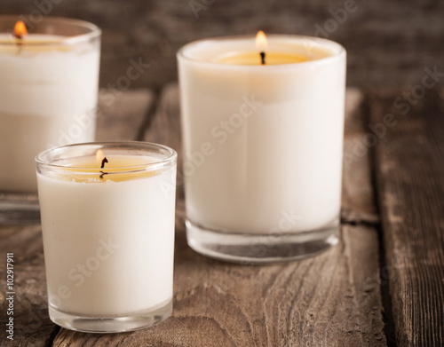 scented candles on old wooden background