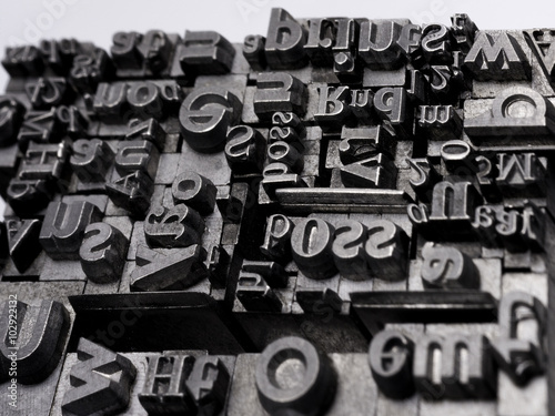 Metal Letterpress Types. A background from many historic typographical letters in black and white with white background. 