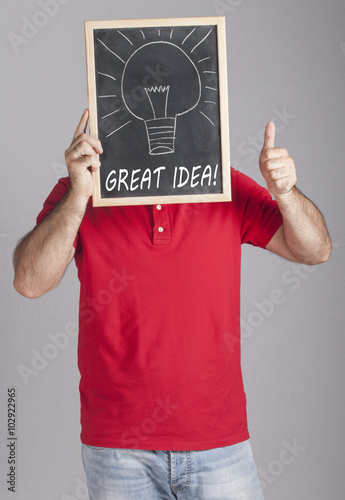 Man holding Great Idea message written on a blackboard photo
