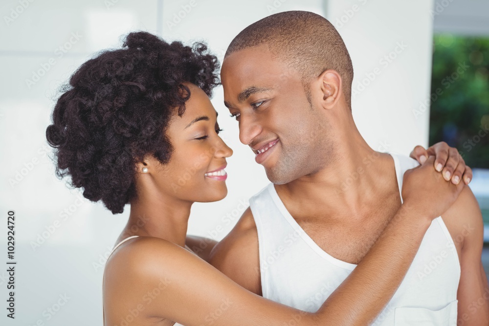 Fototapeta premium Happy couple hugging and looking at each other