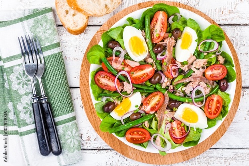 Homemade salad nicoise with tuna, anchovies, tomatoes