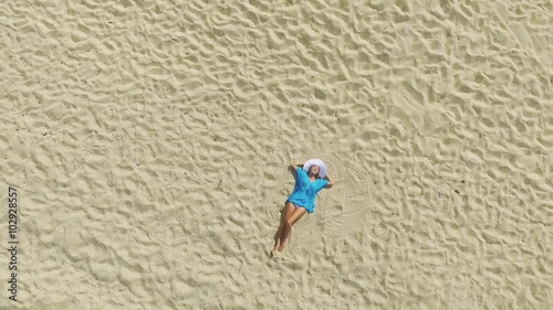 Aerial view of Young beautiful women in the blue on the sunny tropical beach photo