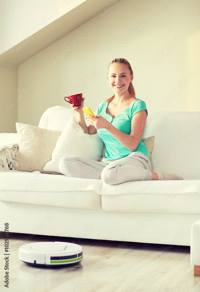 happy woman with smartphone drinking tea at home happy woman with smartphone drinking tea at home