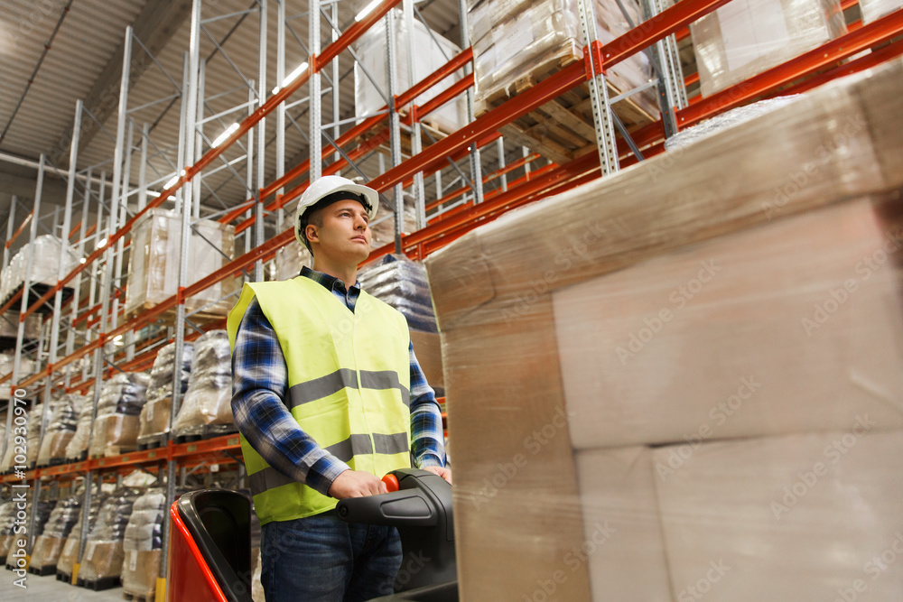 Fototapeta premium man on forklift loading cargo at warehouse