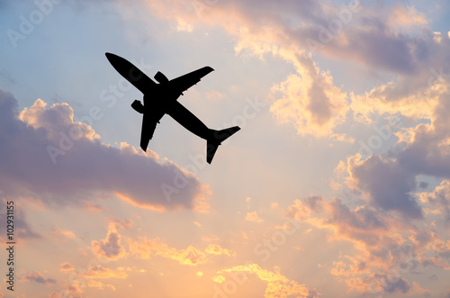 Silhouette Airplane in the sky at sunrise