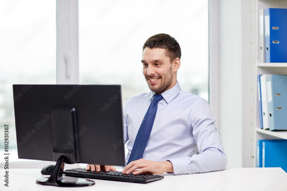 smiling young businessman with computer at office smiling young businessman with computer at office