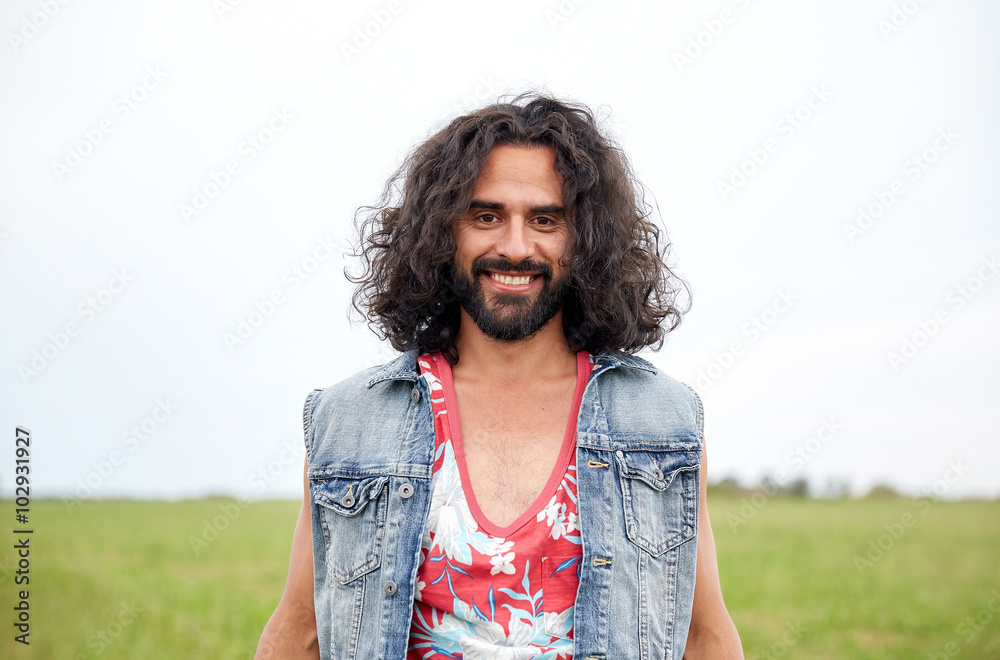 smiling young hippie man on green field Stock Photo | Adobe Stock