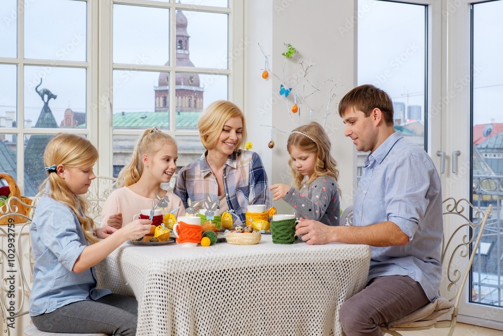 Cheerful family having fun painting and decorating easter eggs. Cheerful family having fun painting and decorating easter eggs.