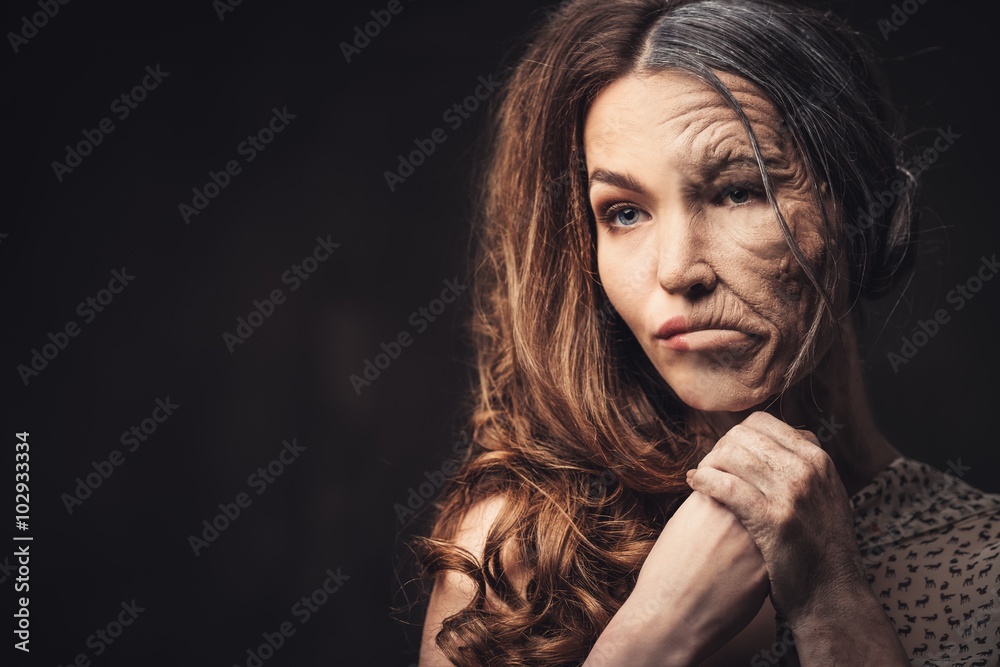 Obraz premium Aging and skin care concept. Half old half young woman.