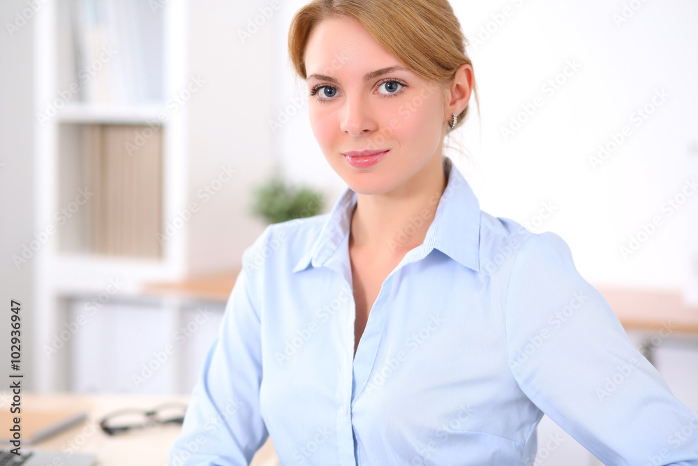 Young blonde business woman with laptop in the office. Business concept. Young blonde business woman with laptop in the office. Business concept.
