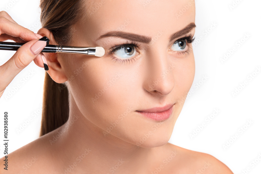 Beautiful female eyes with make-up and brush Beautiful female eyes with make-up and brush