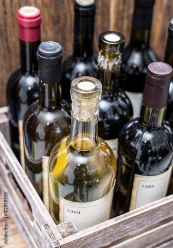 Wine bottles in a wooden crate .