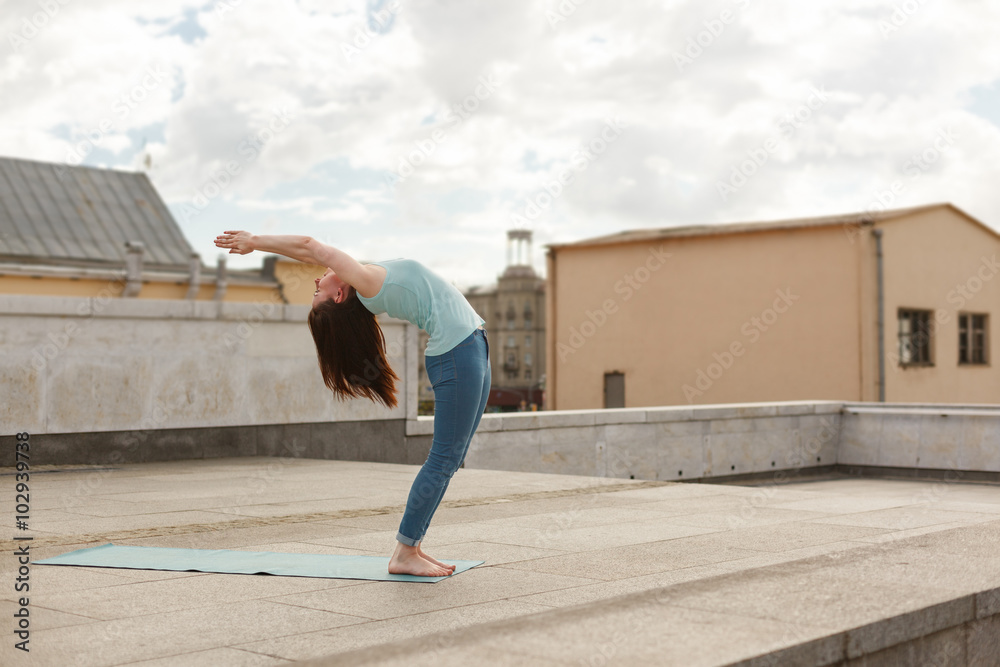 Young woman in a yoga back bend pose